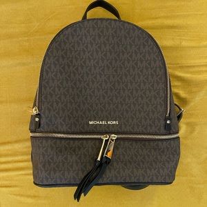 Michael Kors Rhea medium zip backpack. Black brown monogram